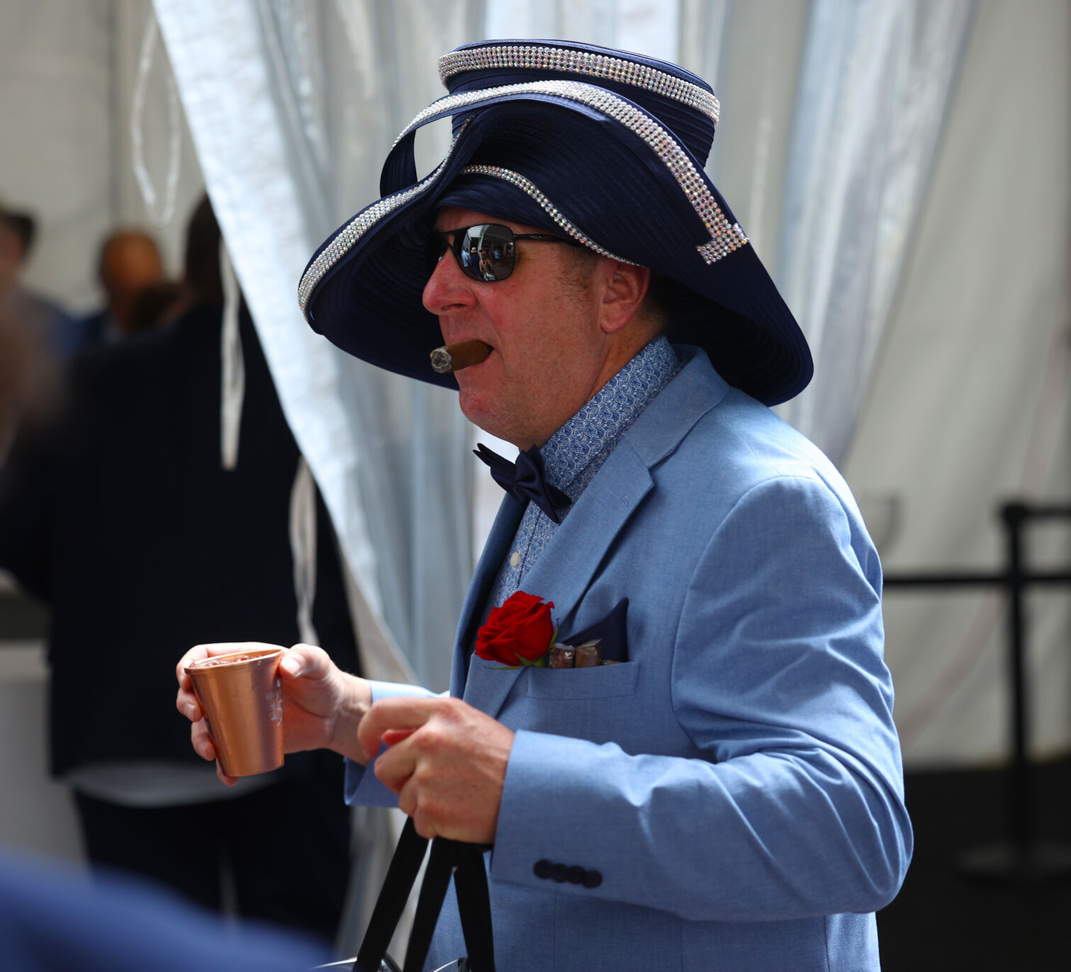 Man with Derby hat walks with cigar.JPG